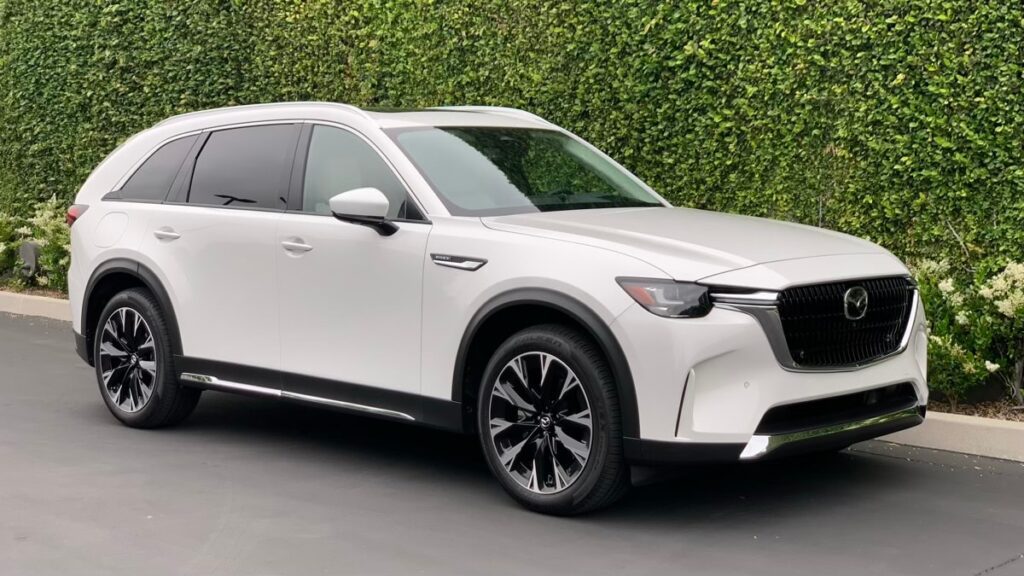 2024 Mazda CX-90 PHEV in white with a green backdrop.