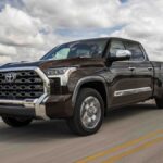 2024 Toyota Tundra 1794 Edition driving down a highway.